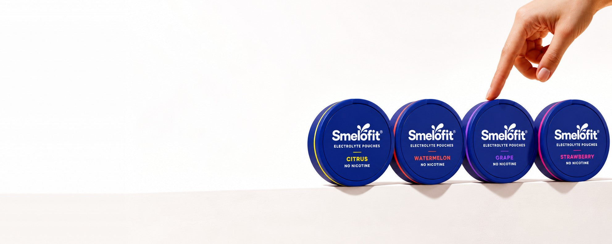 smelo electrolyte pouches tins in different flavors, splashing in pink water with ice and fresh fruit